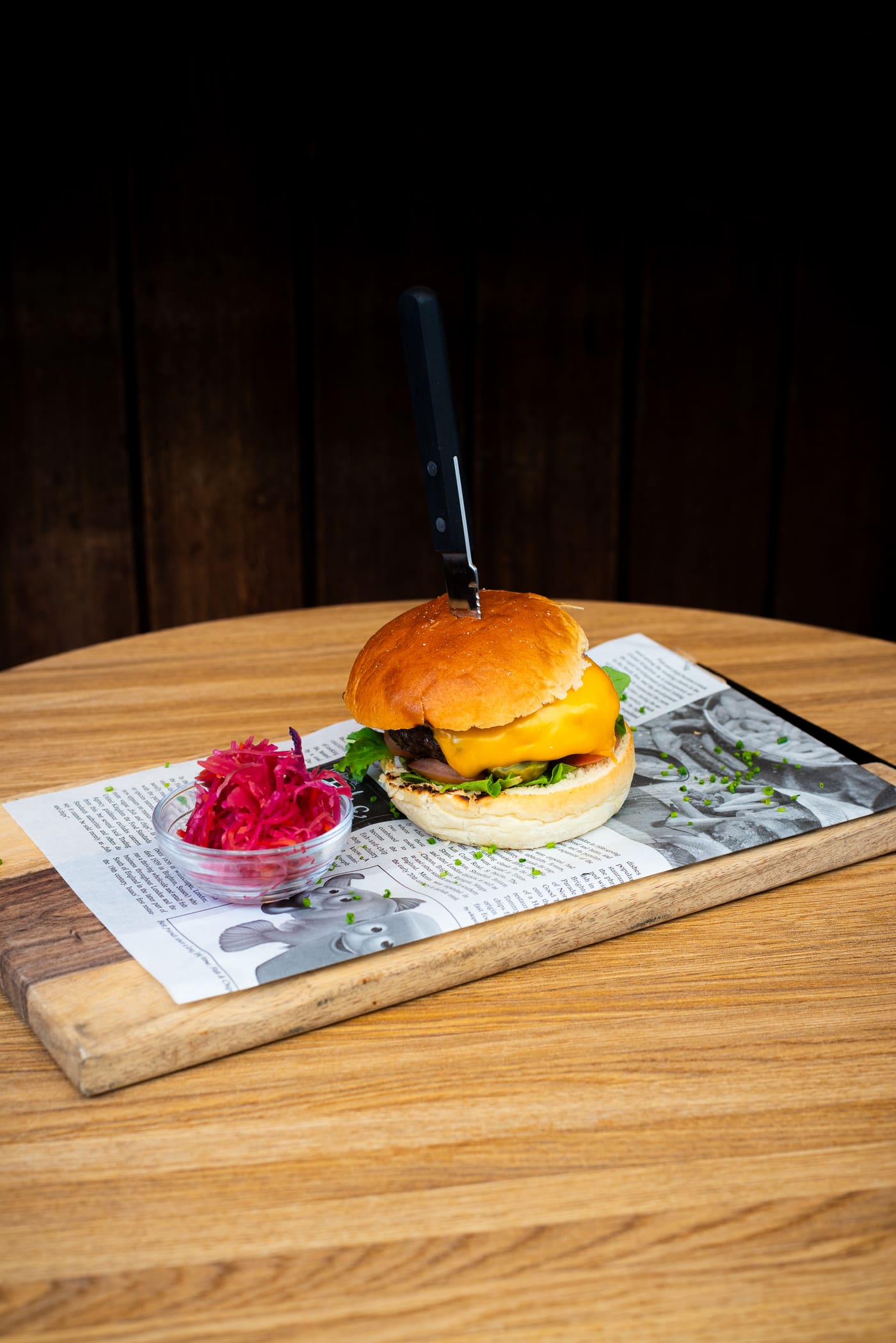 Hamburger op een plank met krantenpapier