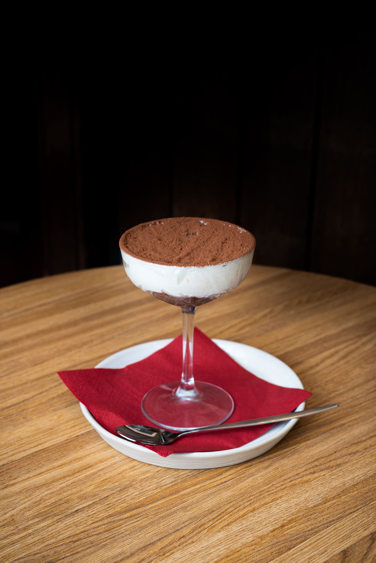 Tiramisu in coupeglas op een rood servet